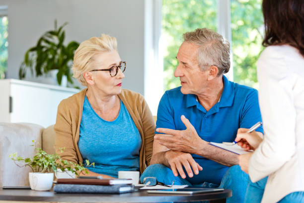 istock Insurance agent planning with a senior couple contract 1218744149