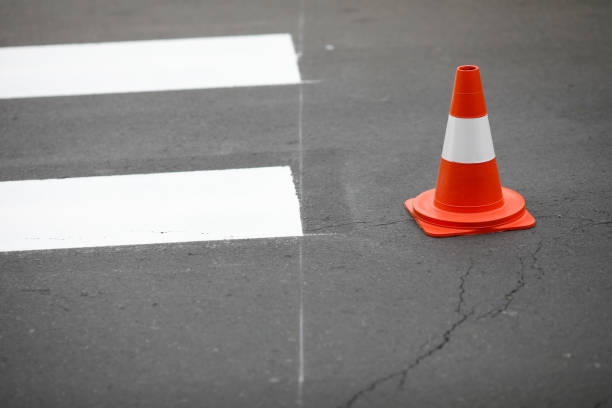 istock Freshly painted crosswalk and a traffic cone - road works concept 1218744214