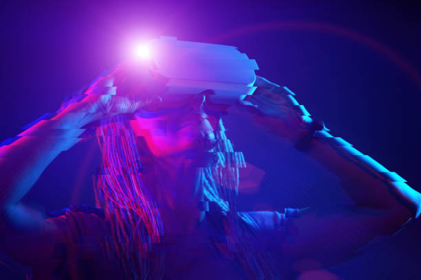 istock Woman is using virtual reality headset. Neon light studio portrait. Image with glitch effect. 1218744888