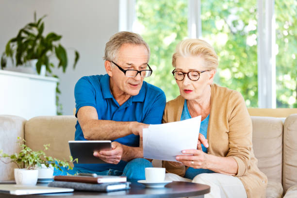 istock Retired couple watching bills and calculating monthly expenses 1218744903