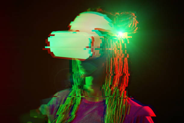 istock Woman is using virtual reality headset. Neon light studio portrait. Image with glitch effect. 1218745035