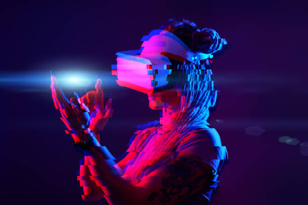 istock Woman is using virtual reality headset. Neon light studio portrait. Image with glitch effect. 1218745135