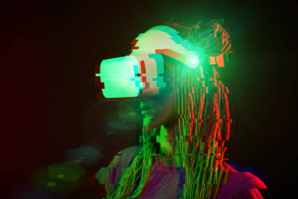 istock Woman is using virtual reality headset. Neon light studio portrait. Image with glitch effect. 1218745349