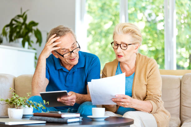 istock Senior couple working out a home budget 1218745376