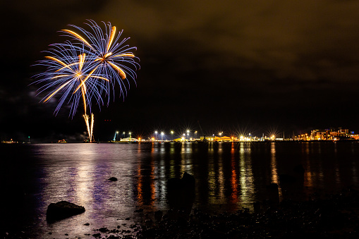 Colour night time photograph of public fireworks display, celebrating Guy Fawkes night on Poole quay, Dorset, England.