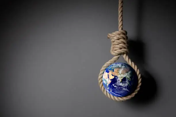 The earth hangs itself with a Hangman’s noose in front of a dark wall.
Elements of this image furnished by NASA
https://eoimages.gsfc.nasa.gov/images/imagerecords/57000/57723/globe_east_2048.jpg
