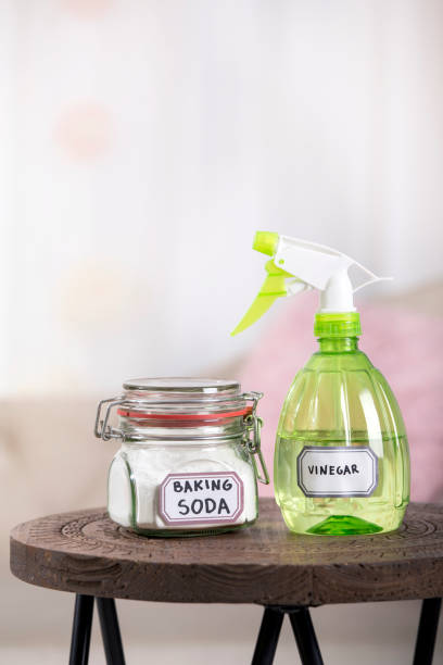 istock Using baking soda Sodium bicarbonate and white vinegar for home cleaning. White vinegar in spray bottle and baking soda in glass jar. 1218750111
