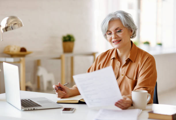 istock Elderly female freelancer working at laptop 1218750181