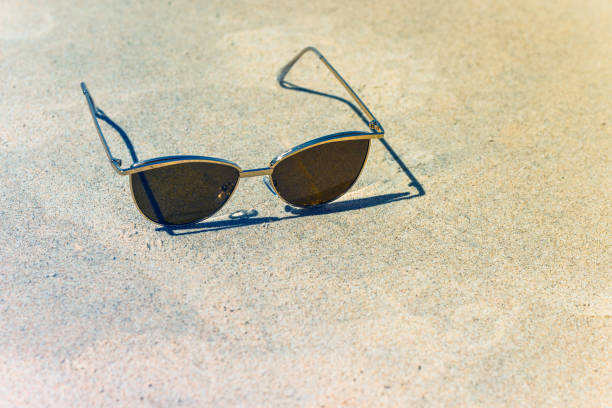 istock women's sunglasses in the sand, accessory from the sun 1218751884