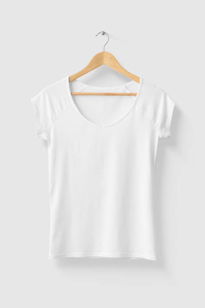 istock Blank White Women's T-Shirt Mock-up on wooden hanger, front side view. 1218753320