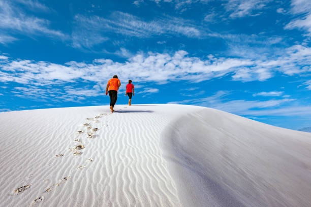 Young hikers are walking in the white desert, New Mexico,USA stock photo