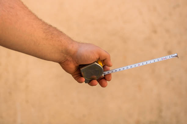 istock Tools for repair and building. Hand holding a ruler on blurred background 1218756454