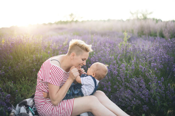 istock Happy mother with little son playing on lavender field 1218757328