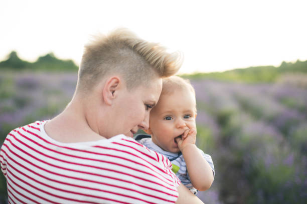istock Happy mother with little son playing on lavender field 1218757392