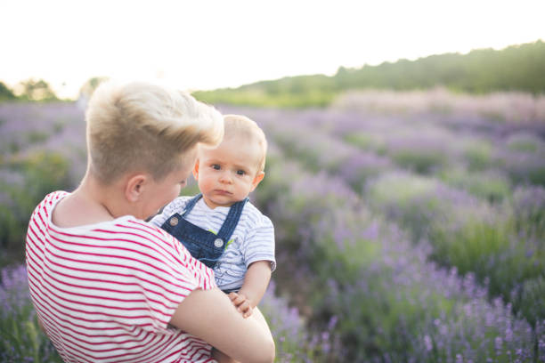 istock Happy mother with little son playing on lavender field 1218757420