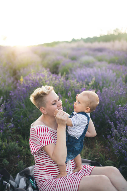 istock Happy mother with little son playing on lavender field 1218757531