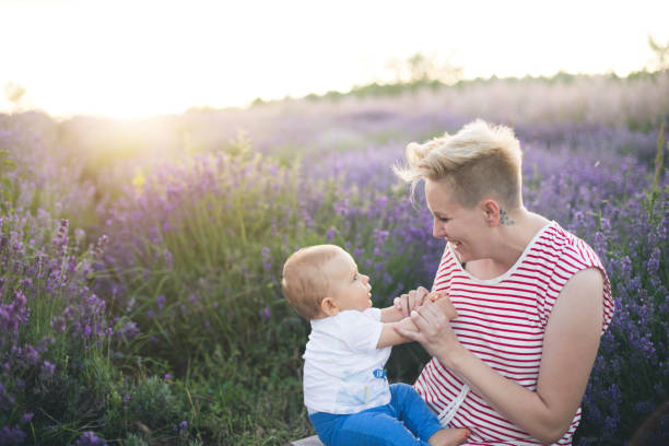 istock Happy mother with little son playing on lavender field 1218757618