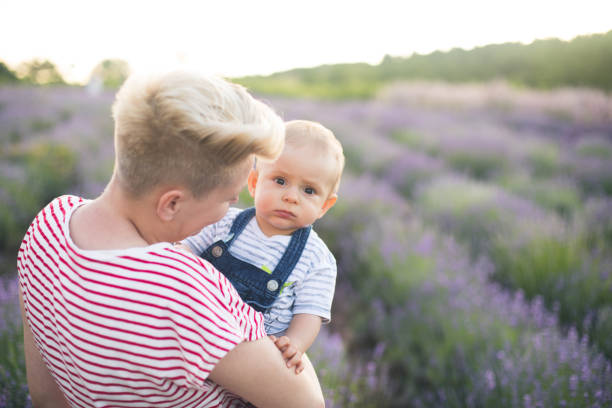 istock Happy mother with little son playing on lavender field 1218757646