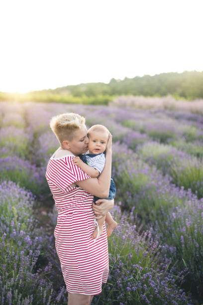 istock Happy mother with little son playing on lavender field 1218757699