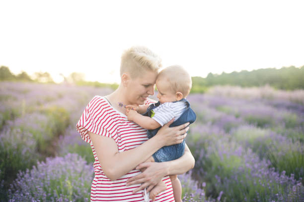 istock Happy mother with little son playing on lavender field 1218758007