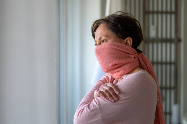 istock Thoughtful woman wearing a face guard 1218758047
