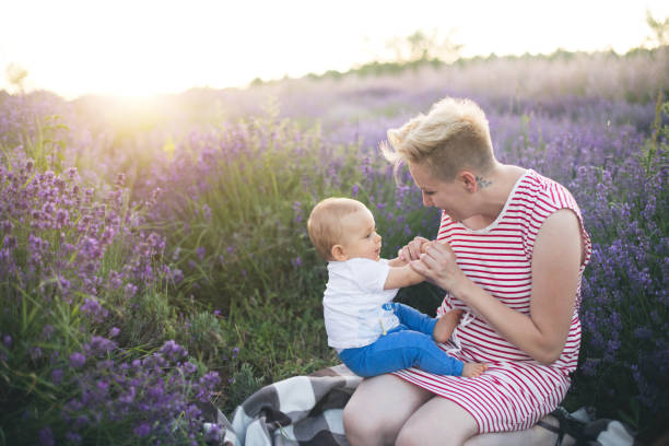 istock Happy mother with little son playing on lavender field 1218758601