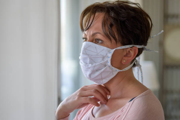 istock Hispanic woman wearing a face mask indoors 1218758611