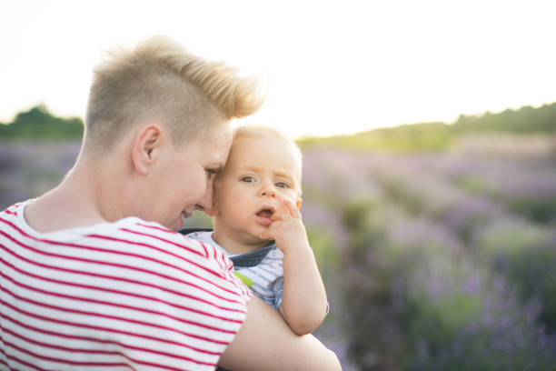 istock Happy mother with little son playing on lavender field 1218758751