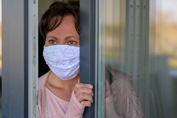 istock Anxious woman wearing a protective face mask 1218758803