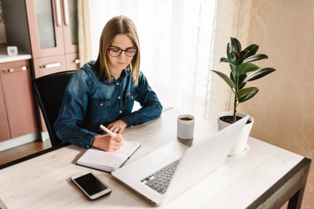 istock Home work. Woman working, learns and using laptop computer on table in home office. Freelance. Writing, typing. Communication and technology concept.  Paperwork. 1218758844
