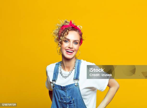 Cheerful Young Woman In 80s Style Outfit Portrait On Yellow Background Stock Photo - Download Image Now