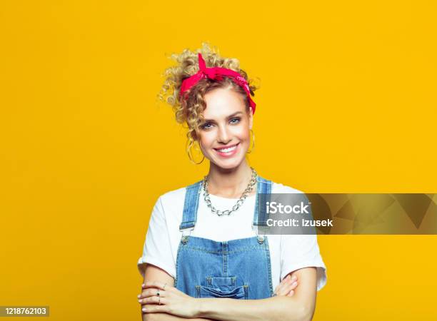 Smiling Young Woman In 80s Style Outfit Portrait On Yellow Background Stock Photo - Download Image Now