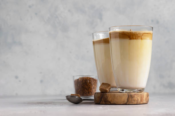 istock Glass with Dalgona frothy coffee. Trend korean drink with coffee foam on light grey stone background. 1218763230