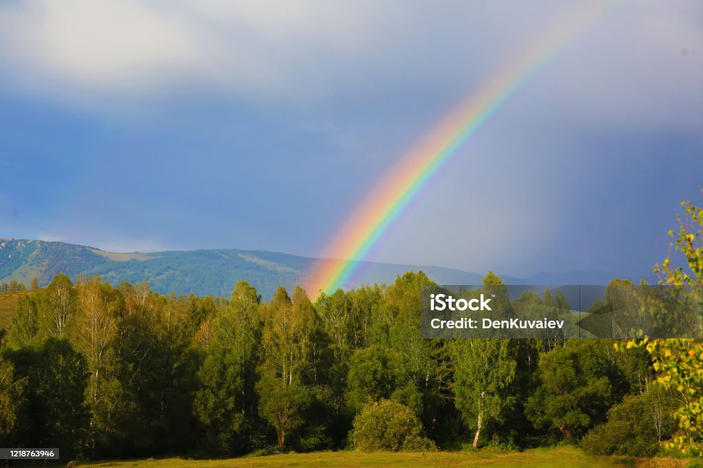 Natural rainbow in the mountains Rainbow Stock Photo