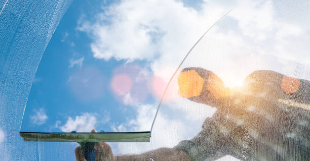 istock window cleaner cleaning window with squeegee and wiper on a sunny day 1218772815