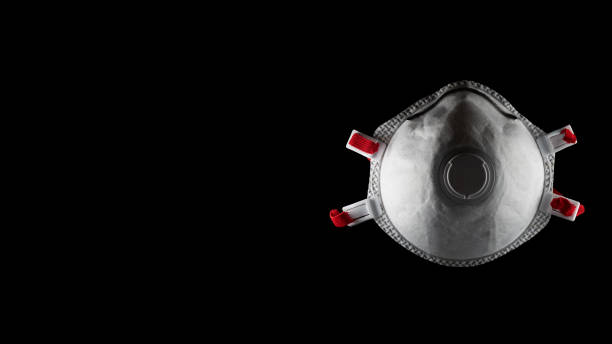 white respirator mask with red straps and black background stock photo
