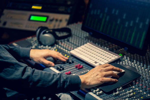 istock sound engineer hands working on audio mixing console, computer and studio equipment in recording, broadcasting, editing studio 1218774296