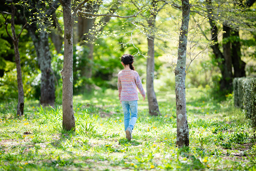 Girl playing in the spring woods