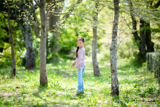 istock Girl playing in the spring woods 1218774357