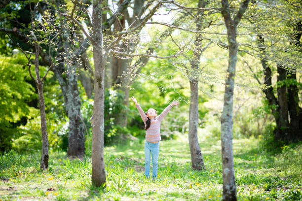 istock Girl playing in the spring woods 1218774425