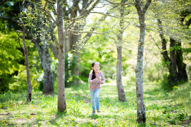istock Girl playing in the spring woods 1218774450