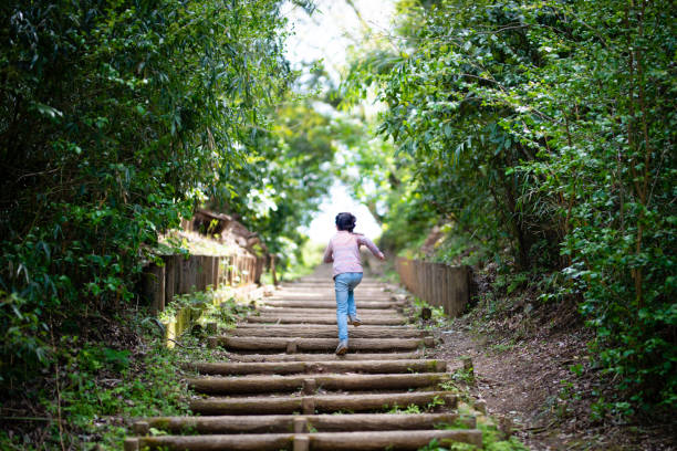 istock Girl climbing stairs in the forest 1218774459