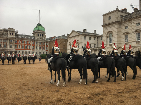 British royal guards perform the changing of the guard at Buckingham Palace.