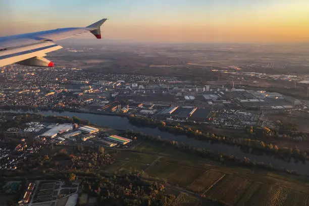 Aerial view of Ruesselsheim and Opel-Werk with main river, Germany at sunset against blue sky