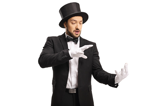 Magician wearing white gloves and performing a trick with his hands isolated on white background