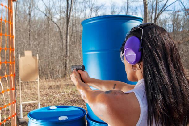 istock Woman shooting cardboard target 1218777334