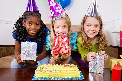 Three girls at a birthday party.