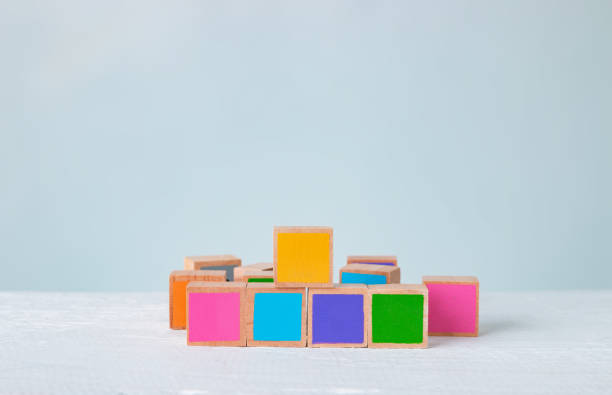 istock Multicolored wooden blocks are disordered on a wooden table, Pastel tones. 1218778884