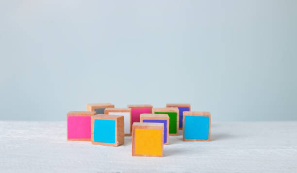 istock Multicolored wooden blocks are disordered on a wooden table, Pastel tones. 1218778922