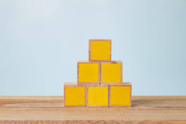 istock 5 yellow painted wooden blocks on a wooden table 1218779008